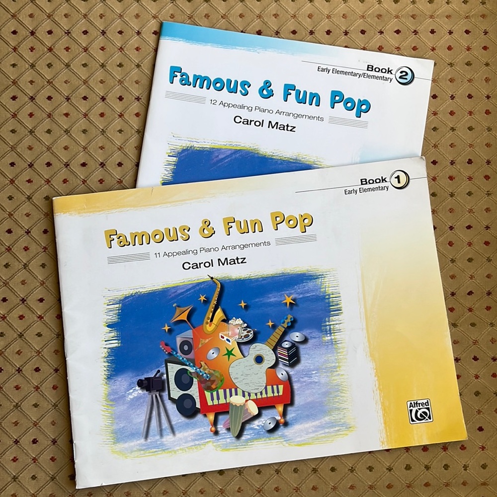 2 pre-loved books of popular music for elementary piano players.